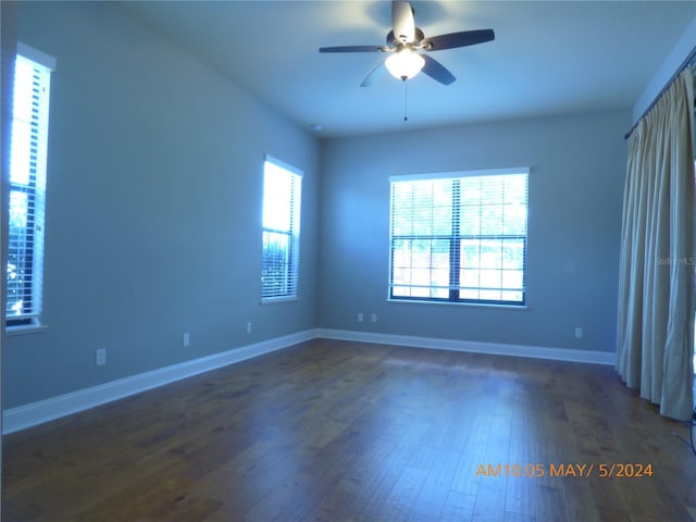 spare room featuring dark hardwood / wood-style floors and ceiling fan