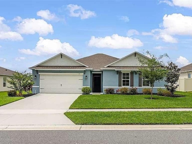 view of front facade featuring a front yard and a garage