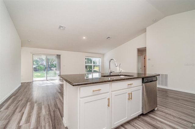 kitchen featuring dishwasher, sink, an island with sink, lofted ceiling, and white cabinets