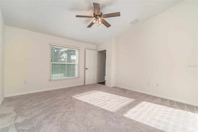 carpeted empty room with ceiling fan and lofted ceiling