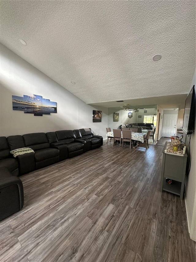 unfurnished living room featuring ceiling fan, wood-type flooring, and a textured ceiling