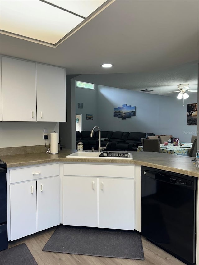 kitchen featuring black appliances, sink, ceiling fan, light hardwood / wood-style floors, and white cabinets