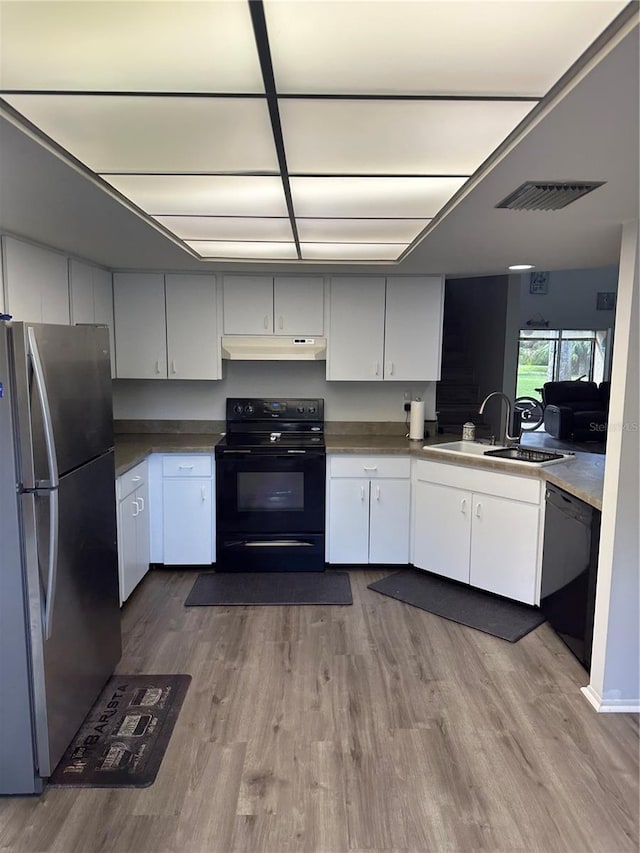 kitchen featuring white cabinetry, black appliances, sink, and light wood-type flooring