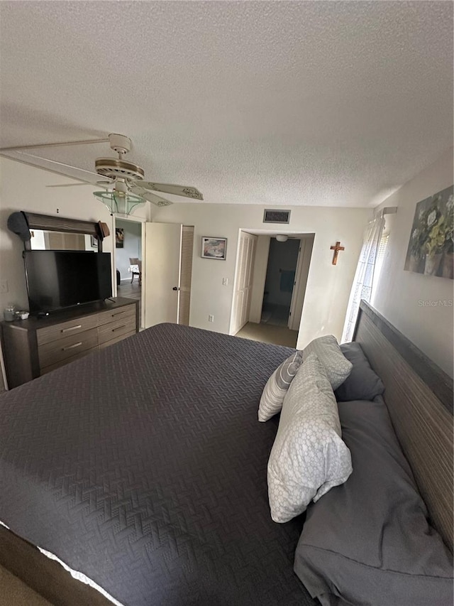 bedroom with a textured ceiling and ceiling fan