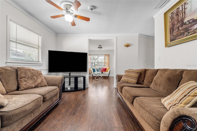 living room featuring ornamental molding, ceiling fan, a textured ceiling, and dark hardwood / wood-style flooring