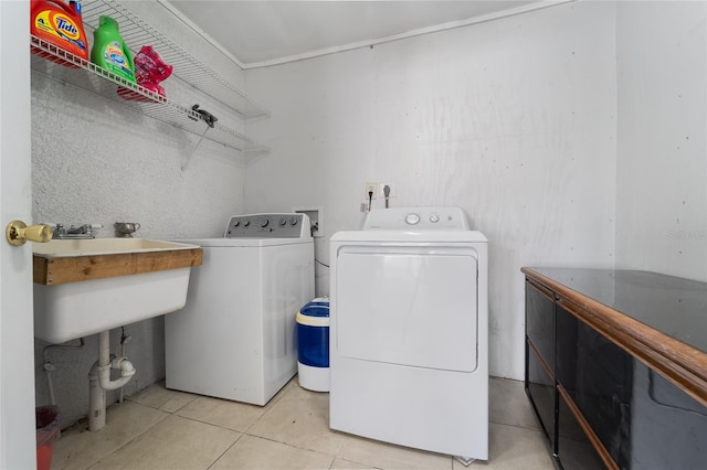 laundry room featuring washer and dryer and light tile patterned floors