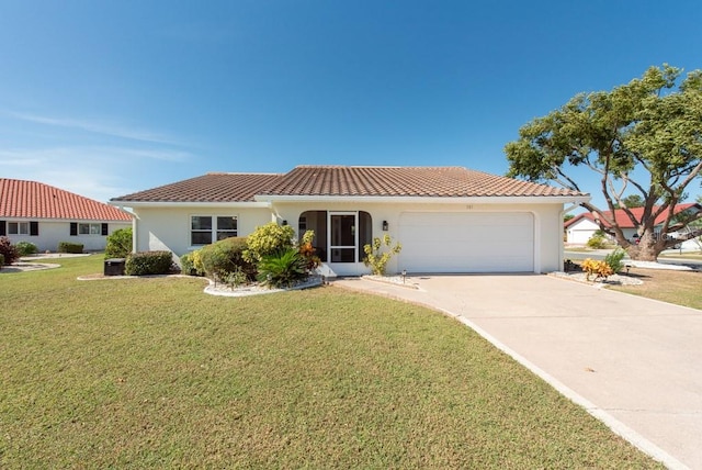 mediterranean / spanish-style home featuring a garage and a front lawn