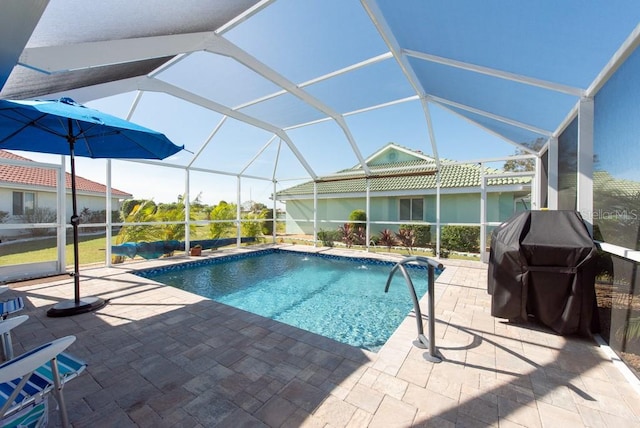 view of pool with a patio area and a lanai