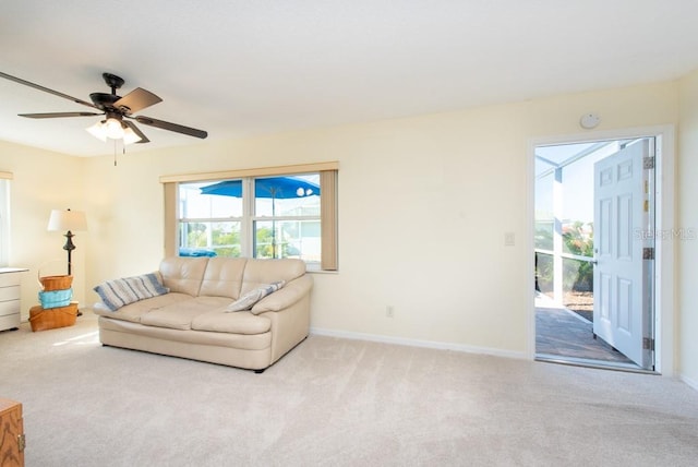 unfurnished living room with light colored carpet and ceiling fan