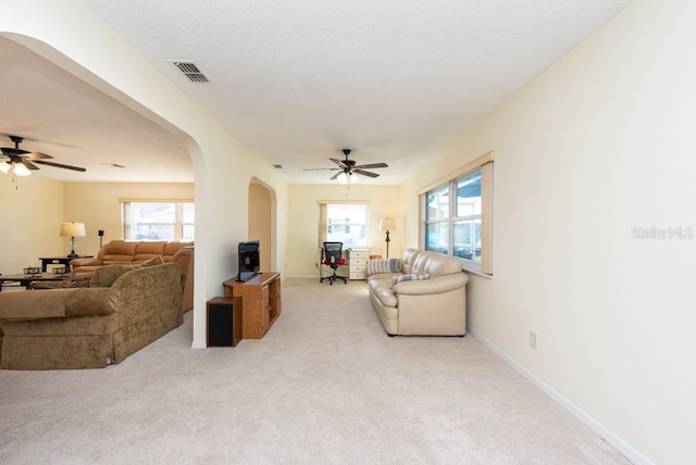 carpeted living room featuring ceiling fan