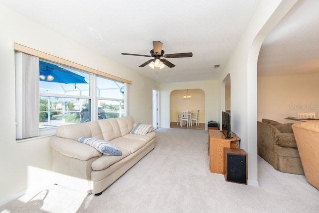 living room featuring light carpet and ceiling fan