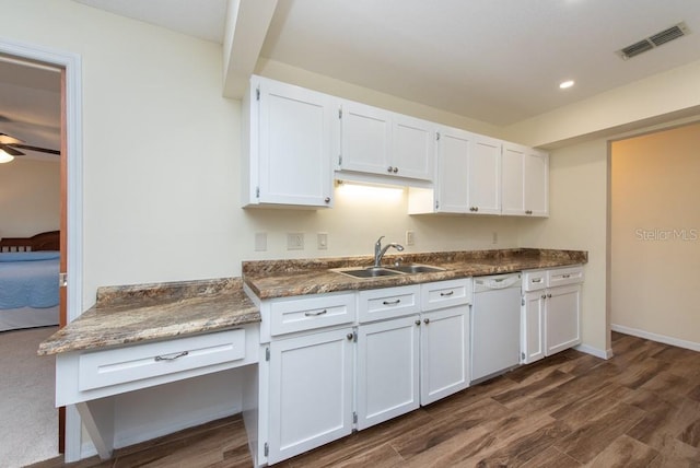 kitchen featuring white dishwasher, sink, white cabinets, and dark wood-type flooring