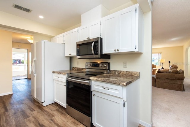 kitchen featuring stainless steel appliances and white cabinets