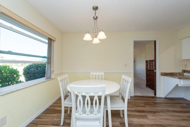 dining space with an inviting chandelier and wood-type flooring