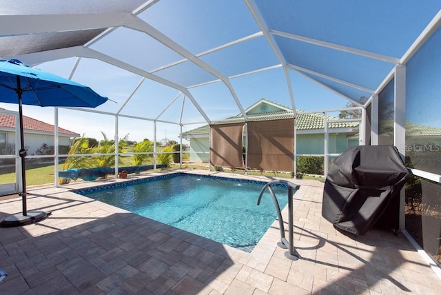 view of pool with a grill, a patio, and a lanai