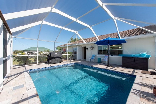 view of swimming pool featuring a patio area, a lanai, and a grill