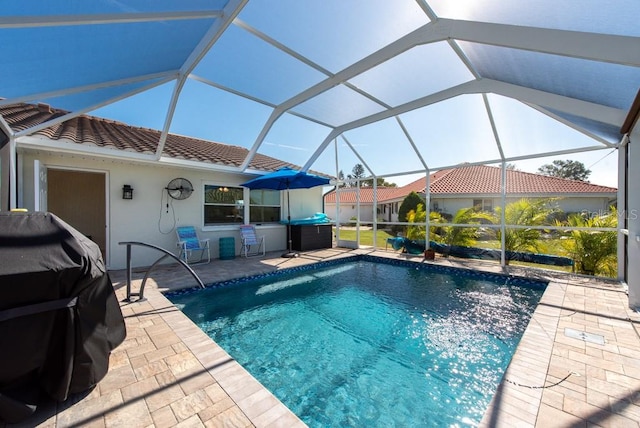 view of swimming pool with a patio and glass enclosure