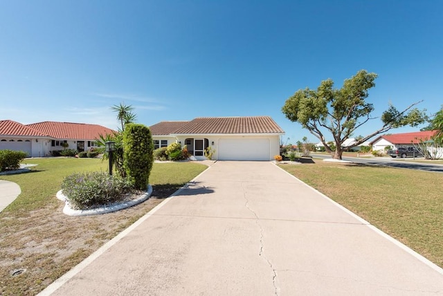 mediterranean / spanish house with a garage and a front lawn