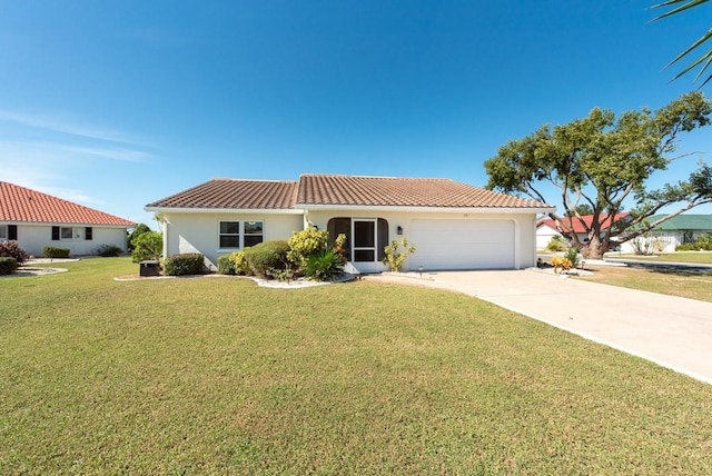 mediterranean / spanish house featuring a front lawn and a garage