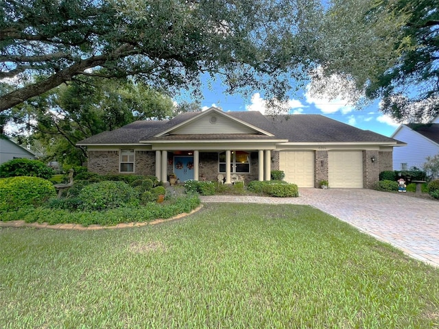 single story home with a garage, a front lawn, and a porch