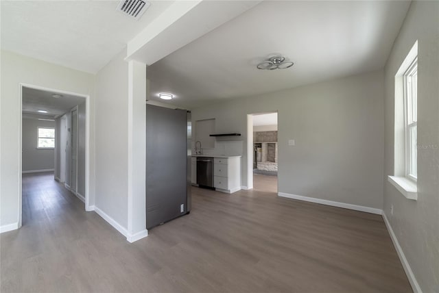 hall with light hardwood / wood-style flooring and sink