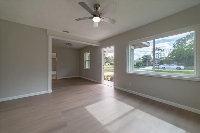 unfurnished room with hardwood / wood-style floors and ceiling fan