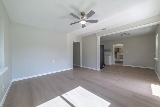 1328 Barry St, Clearwater, FL 33756 - spare room with ceiling fan, wood finished floors, and baseboards