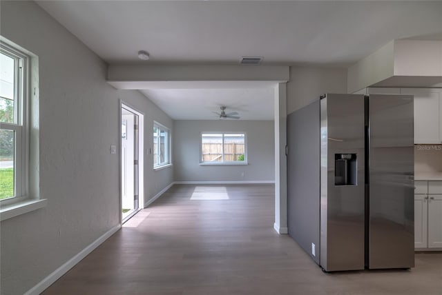 corridor with light hardwood / wood-style floors