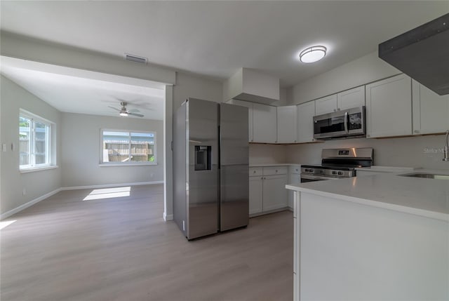 kitchen with stainless steel appliances, ceiling fan, sink, light hardwood / wood-style flooring, and white cabinets