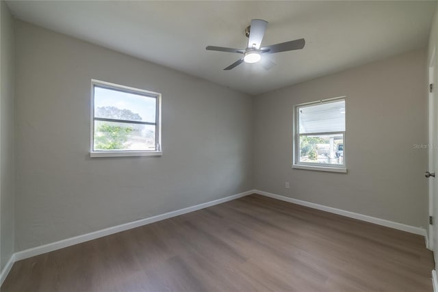 unfurnished room with hardwood / wood-style floors, ceiling fan, and a wealth of natural light