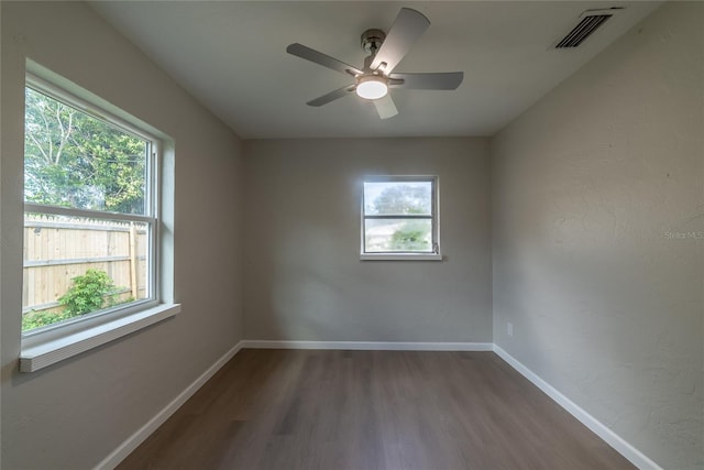 spare room featuring ceiling fan, plenty of natural light, and hardwood / wood-style flooring