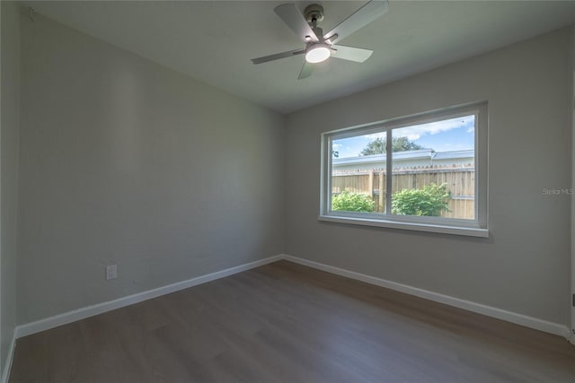 empty room featuring dark hardwood / wood-style floors and ceiling fan