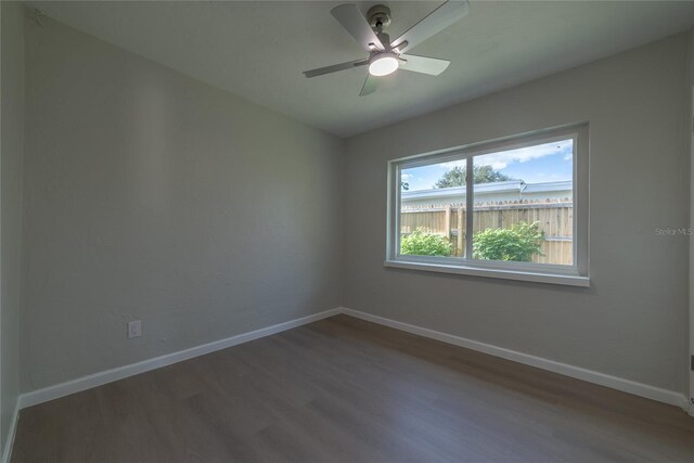 1328 Barry St, Clearwater, FL 33756 - unfurnished room with wood finished floors, baseboards, and ceiling fan
