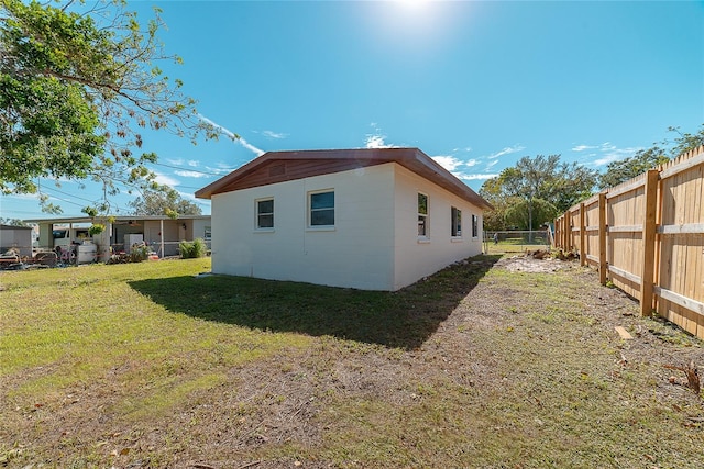 view of side of home featuring a lawn