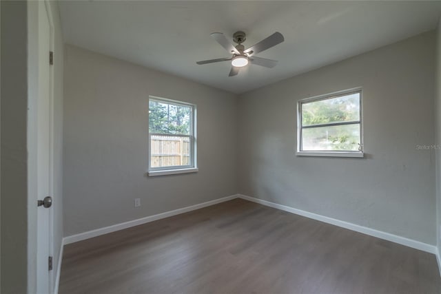 unfurnished room with hardwood / wood-style flooring, ceiling fan, and a healthy amount of sunlight