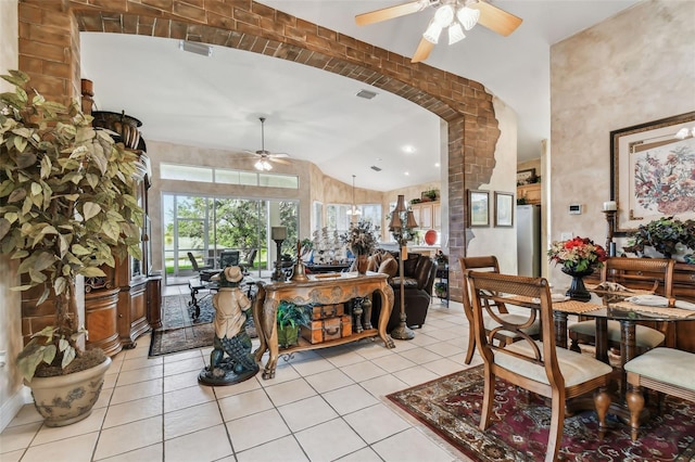 dining room with lofted ceiling, ceiling fan, and light tile patterned floors