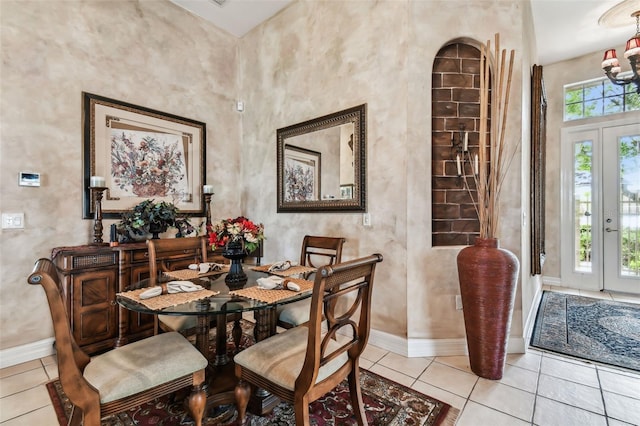 dining room featuring a notable chandelier and light tile patterned flooring