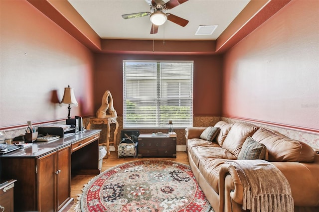 home office with light hardwood / wood-style flooring and ceiling fan