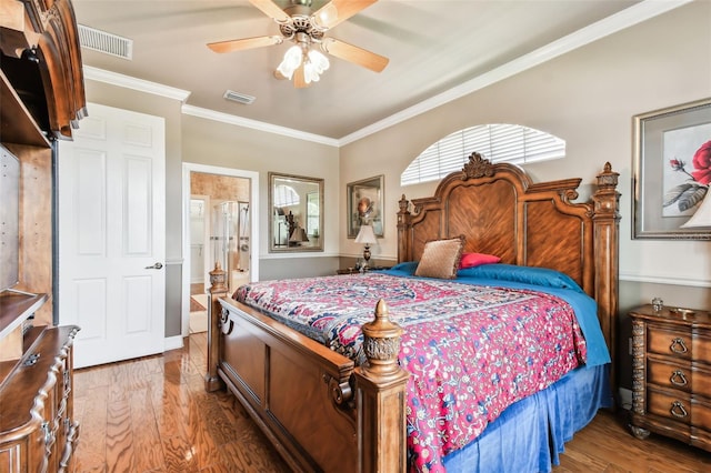 bedroom with ceiling fan, crown molding, ensuite bath, and hardwood / wood-style floors