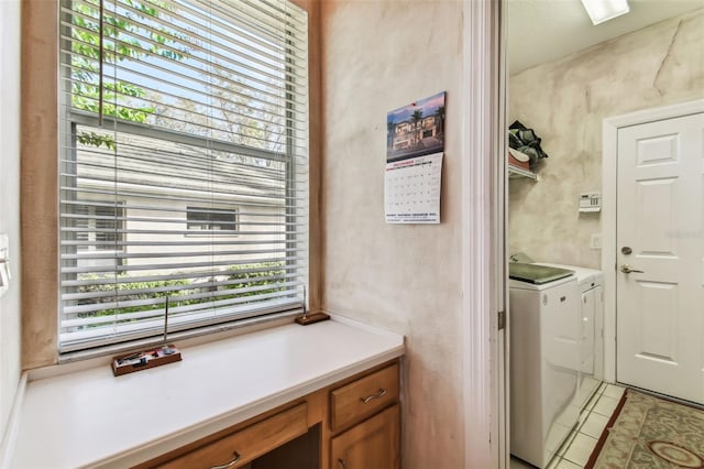 clothes washing area featuring light tile patterned floors and separate washer and dryer