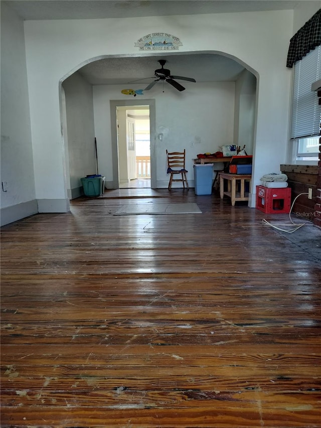 interior space featuring dark wood-type flooring and ceiling fan