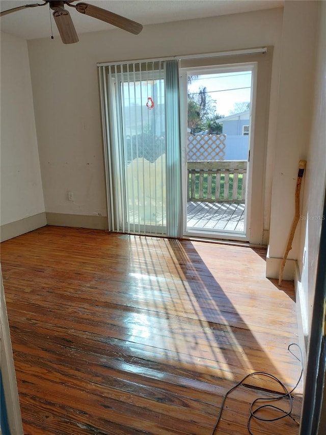 unfurnished room with ceiling fan and wood-type flooring