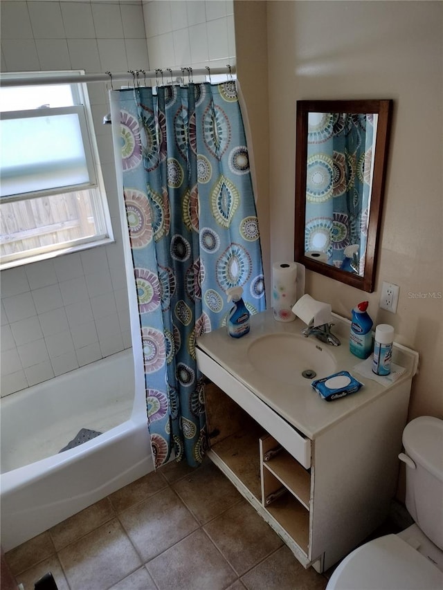 bathroom with toilet, vanity, and tile patterned flooring