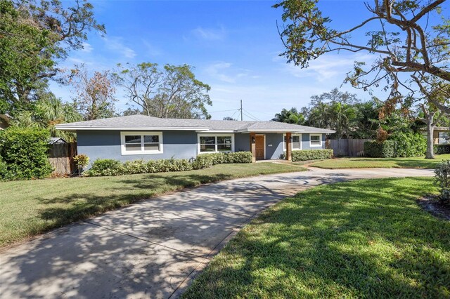 ranch-style home featuring a front yard