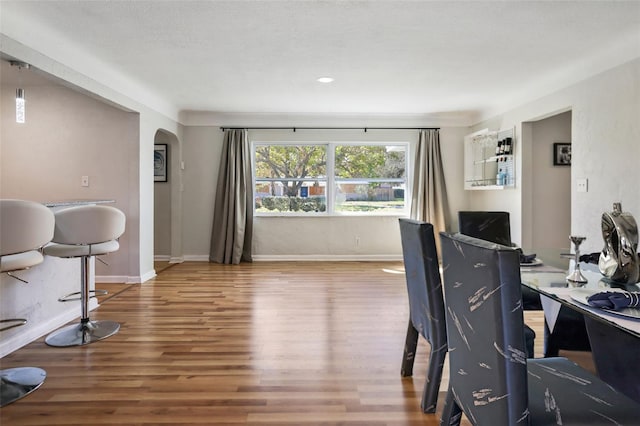 home office with a textured ceiling and hardwood / wood-style floors