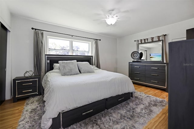 bedroom with ceiling fan and light wood-type flooring