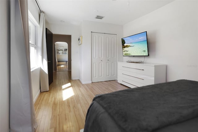 bedroom with a closet and light hardwood / wood-style floors