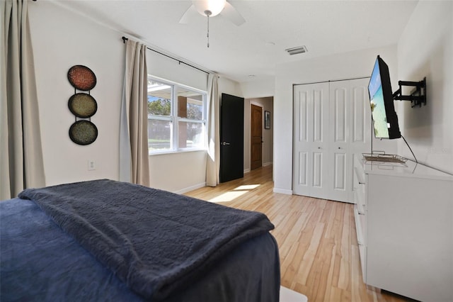 bedroom featuring a closet, light hardwood / wood-style floors, and ceiling fan