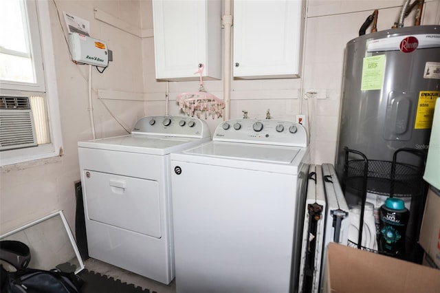 washroom featuring water heater, cooling unit, washer and dryer, and cabinets