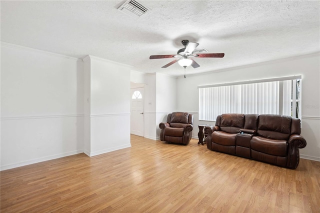 living room with ornamental molding and light hardwood / wood-style flooring